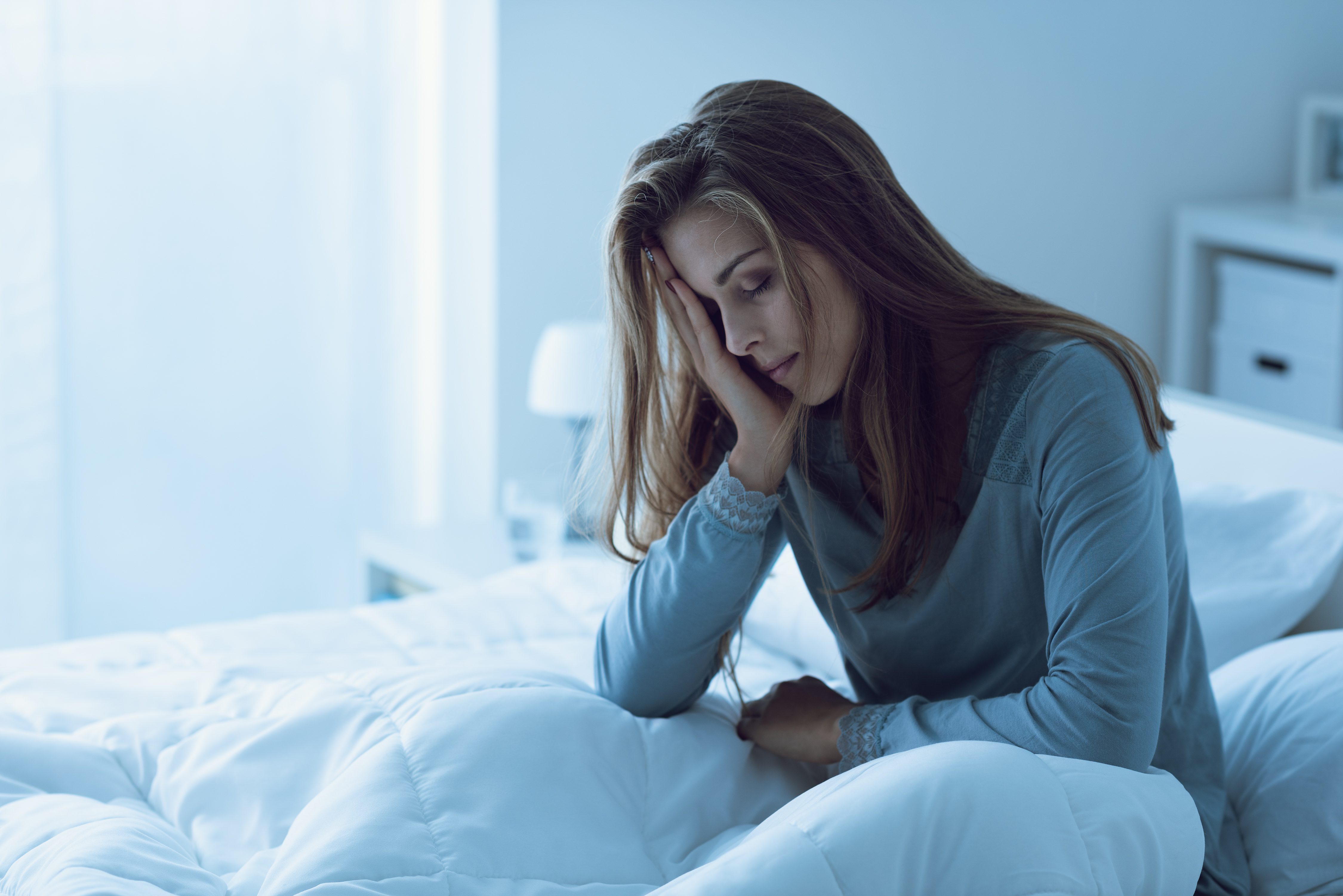 a woman sitting on a bed