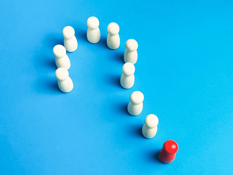 a group of white figures with a red one standing out